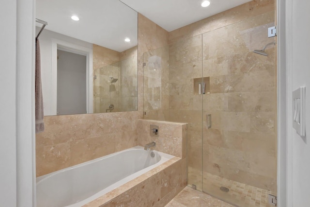 bathroom featuring separate shower and tub