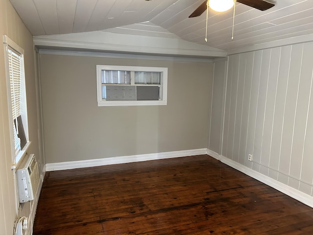 spare room featuring a wall mounted air conditioner, ceiling fan, dark hardwood / wood-style flooring, and lofted ceiling