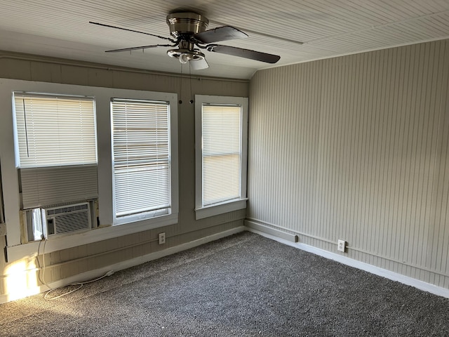 empty room with carpet flooring, ceiling fan, and cooling unit