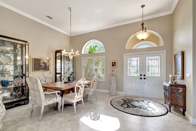 entryway with crown molding, light tile patterned flooring, an inviting chandelier, and french doors