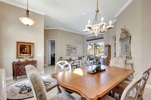 dining space featuring ornamental molding, a towering ceiling, and a chandelier