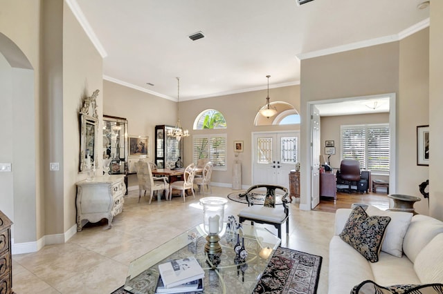 tiled living room featuring ornamental molding and a chandelier