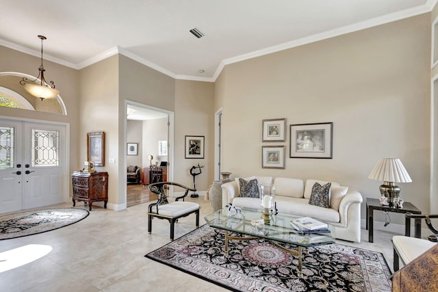 living room featuring crown molding, plenty of natural light, french doors, and a high ceiling