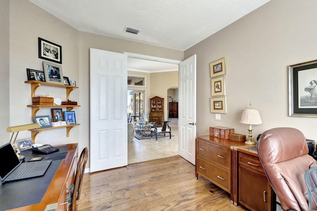 office space featuring a textured ceiling and light hardwood / wood-style floors