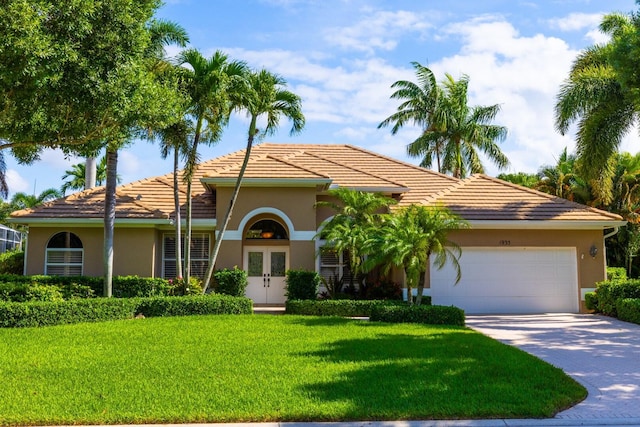 view of front facade with a garage and a front lawn