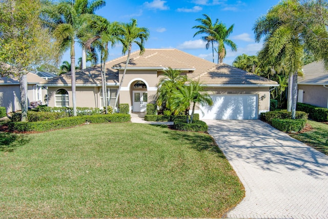 view of front of house featuring a garage and a front lawn