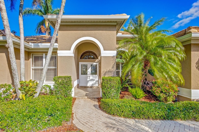 1935 SW Whitemarsh Way, Palm City, FL 34990 - property entrance featuring stucco siding
