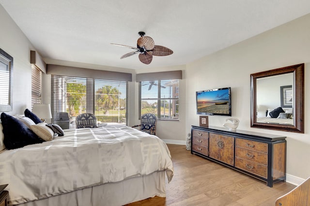 bedroom with ceiling fan and light hardwood / wood-style floors