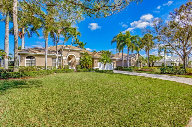 entrance to property featuring a garage and a lawn