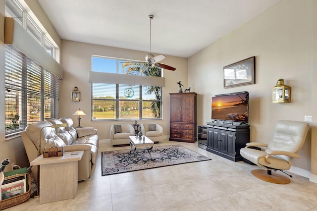 tiled living room with ceiling fan