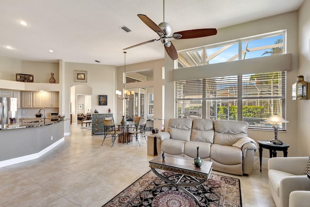 1935 SW Whitemarsh Way, Palm City, FL 34990 - living area with a chandelier, arched walkways, ceiling fan, recessed lighting, and a high ceiling