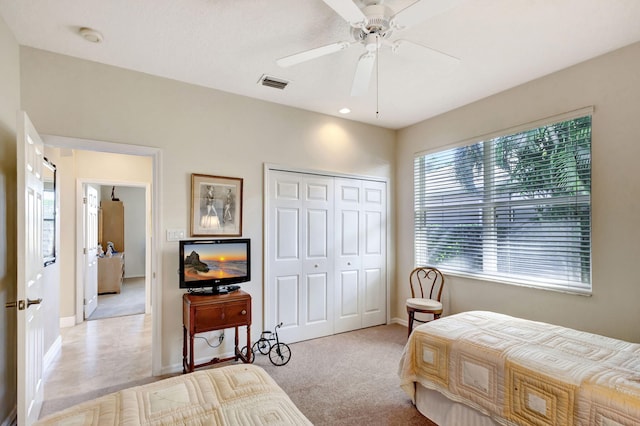 1935 SW Whitemarsh Way, Palm City, FL 34990 - bedroom with baseboards, a closet, light carpet, and a ceiling fan