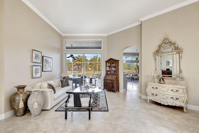 living room with crown molding and ceiling fan