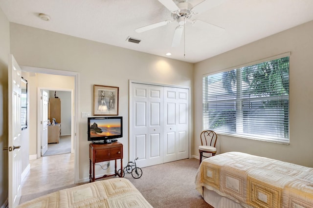 carpeted bedroom with a closet and ceiling fan