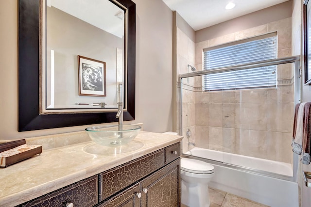 full bathroom with tile patterned flooring, vanity, shower / bath combination with glass door, and toilet