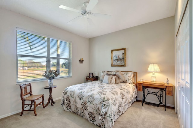 carpeted bedroom featuring a closet and ceiling fan