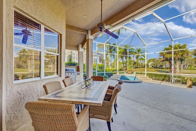 view of patio featuring ceiling fan, a lanai, and a hot tub