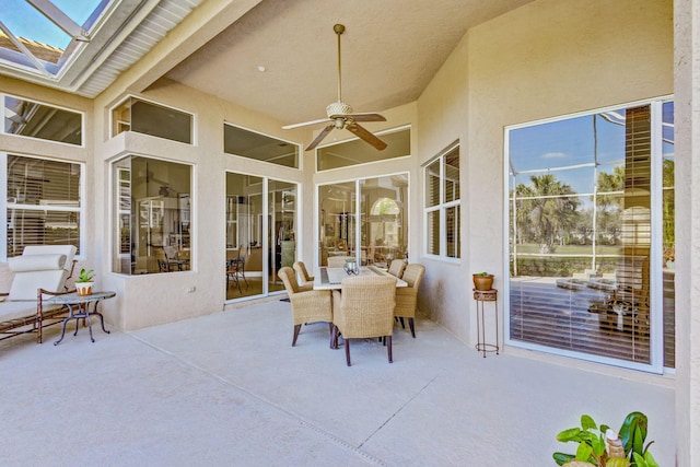 sunroom / solarium with ceiling fan and a skylight