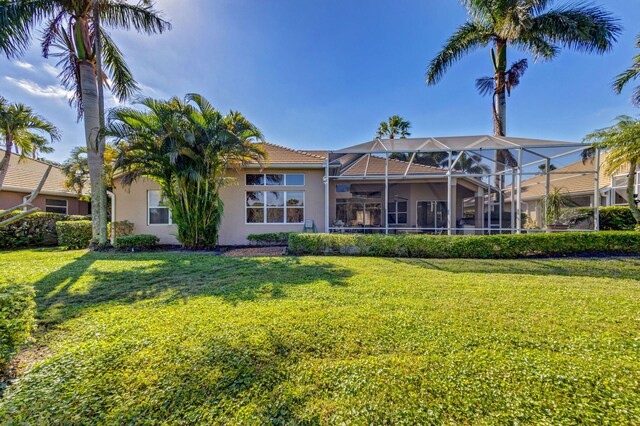 1935 SW Whitemarsh Way, Palm City, FL 34990 - rear view of house featuring stucco siding and a yard
