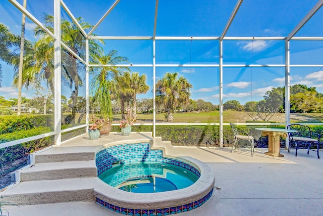 view of pool with a lanai, a patio area, and an in ground hot tub