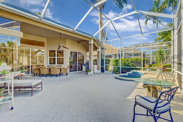 exterior space with a hot tub, a lanai, and ceiling fan