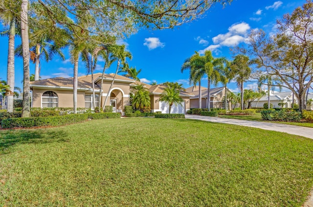 1935 SW Whitemarsh Way, Palm City, FL 34990 - view of front of home with concrete driveway, an attached garage, stucco siding, and a front yard