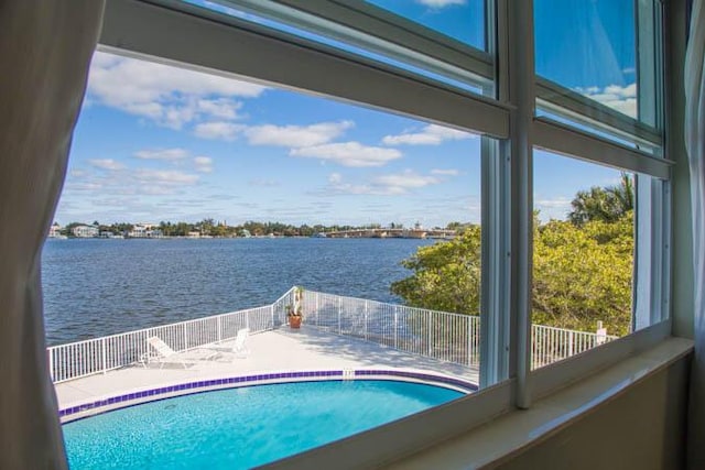 view of pool with a water view