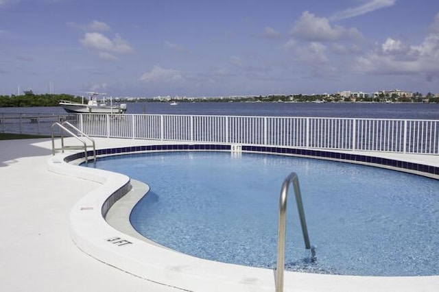 view of pool with a water view