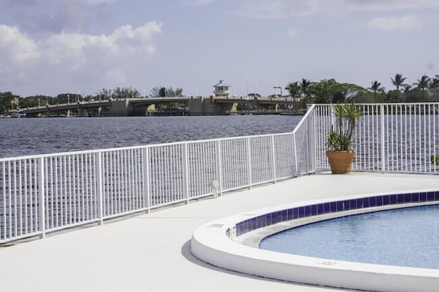 view of swimming pool featuring a water view