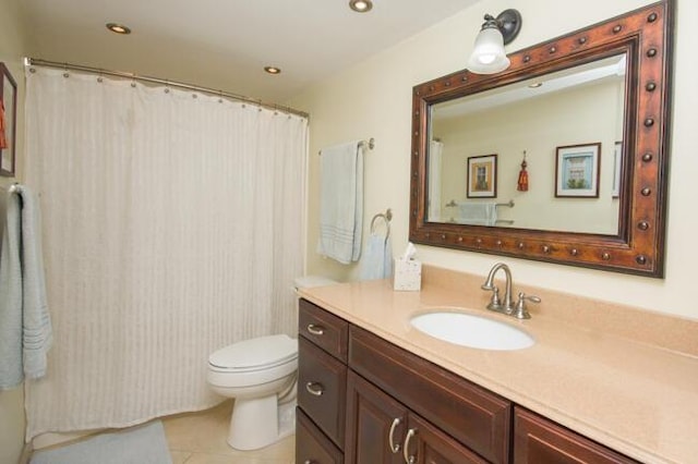 bathroom with tile patterned flooring, vanity, and toilet