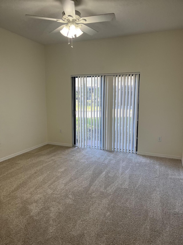 spare room featuring carpet flooring and ceiling fan