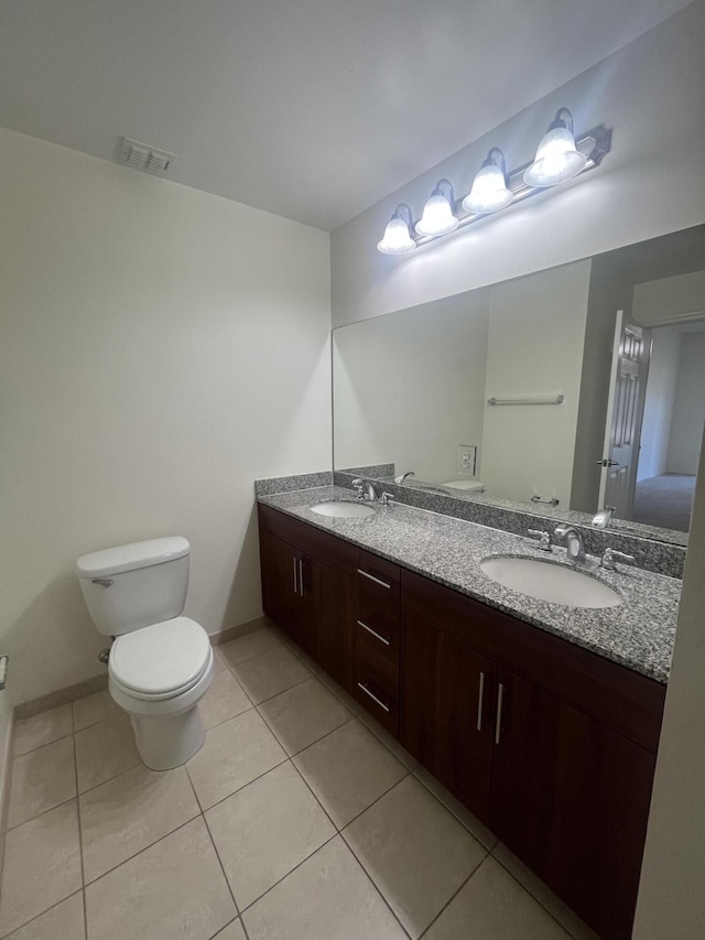 bathroom with tile patterned floors, vanity, and toilet