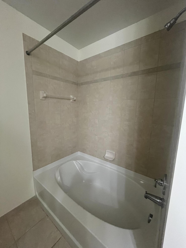 bathroom with tile patterned flooring and tiled shower / bath combo