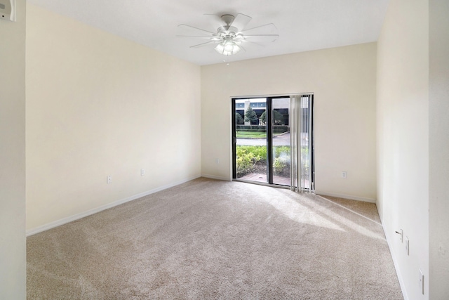 carpeted empty room with a ceiling fan and baseboards