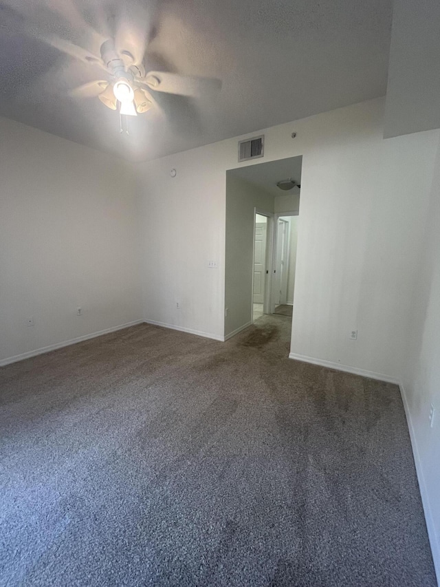 unfurnished room featuring carpet flooring, a textured ceiling, and ceiling fan