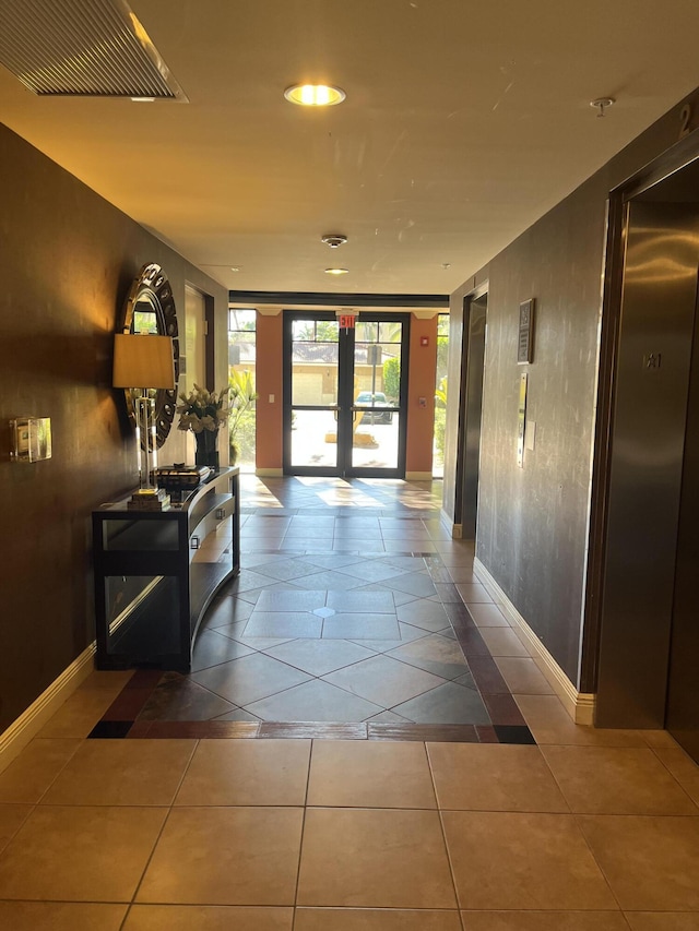 hallway with french doors and tile patterned floors