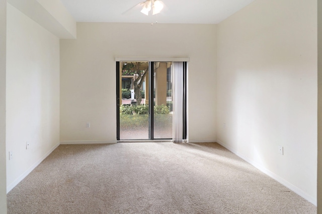 spare room with carpet, ceiling fan, and baseboards