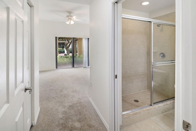 full bathroom featuring a stall shower, tile patterned flooring, ceiling fan, and baseboards