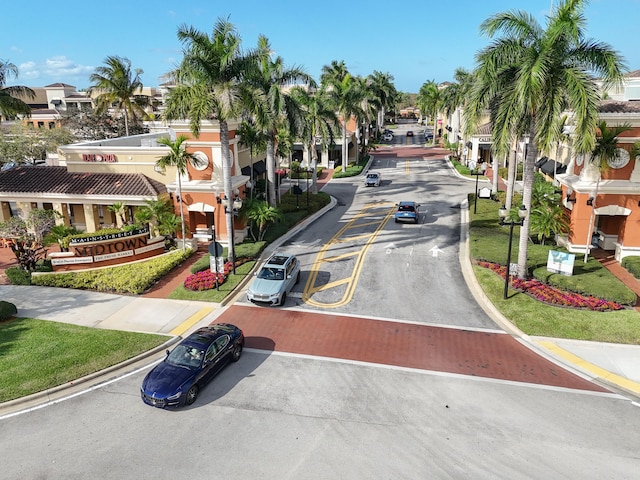 view of street featuring curbs, street lighting, sidewalks, and a residential view