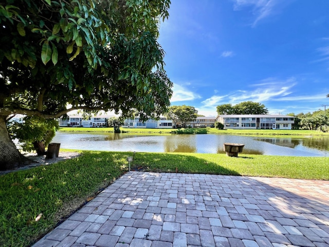 view of home's community featuring a yard and a water view