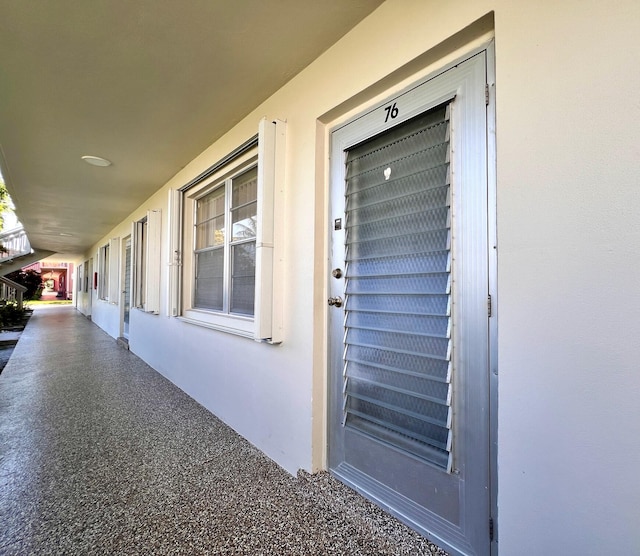 76 Sheffield D, West Palm Beach, FL 33417 - view of exterior entry featuring stucco siding