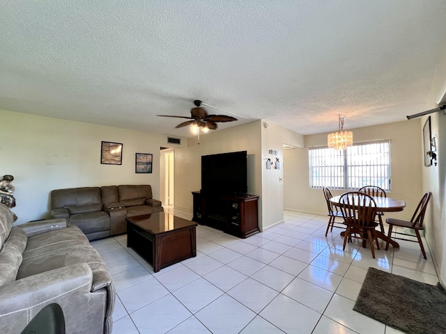 76 Sheffield D, West Palm Beach, FL 33417 - living area with a textured ceiling, a chandelier, light tile patterned floors, a ceiling fan, and baseboards