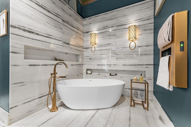 bathroom with tile patterned floors, a bathtub, and tile walls