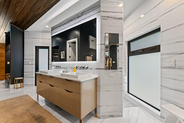 bathroom with vanity and tile walls