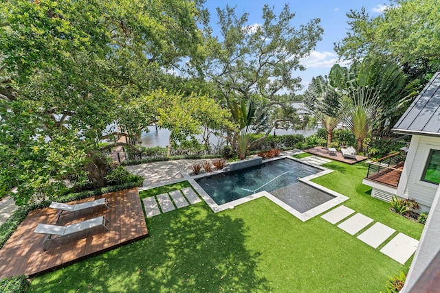 view of yard with a patio area and a swimming pool side deck with water view