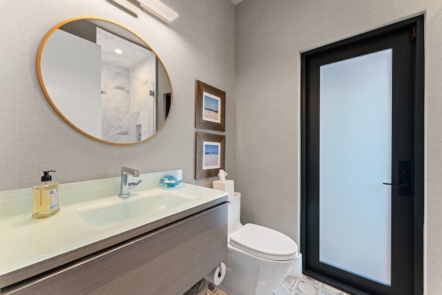 bathroom with vanity, toilet, and walk in shower