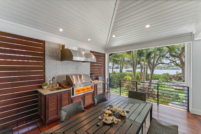 wooden deck with sink and a grill