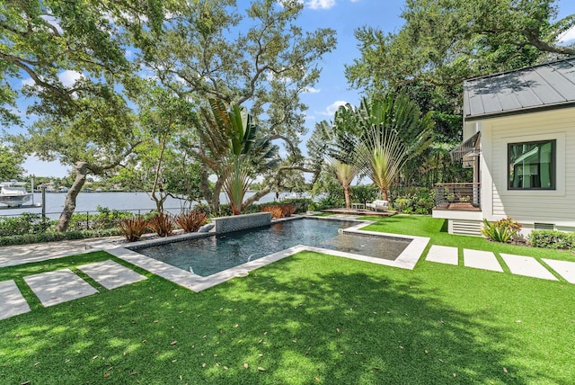 view of swimming pool with a yard