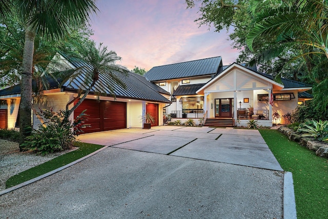 modern farmhouse with covered porch and a garage