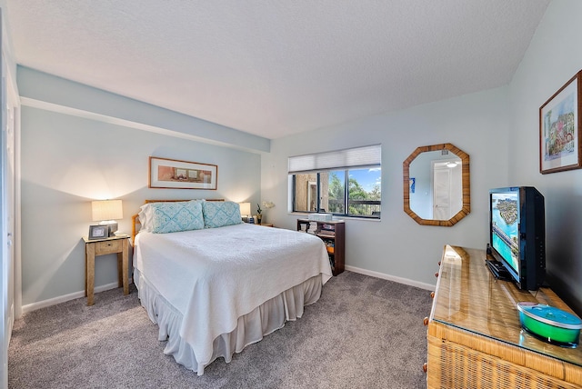 carpeted bedroom featuring a textured ceiling